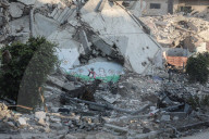 Palestinians amidst Gaza City rubble