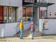 Two Seniors In Front Of A Retirement Home