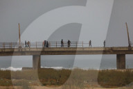 People walk along al-Rashid street between Gaza City and Nuseirat in the central Gaza Strip