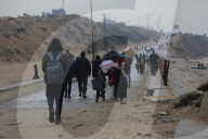 People walk along al-Rashid street between Gaza City and Nuseirat in the central Gaza Strip