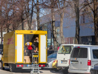 DHL Delivery Worker Unloading Packages