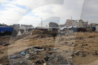Gazans live in makeshift tents amidst building ruins