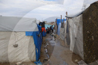 Gazans live in makeshift tents amidst building ruins