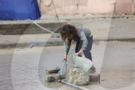 Gazans live in makeshift tents amidst building ruins