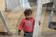 Gazans live in makeshift tents amidst building ruins