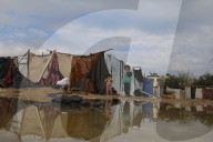 Gazans live in makeshift tents amidst building ruins