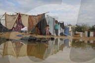 Gazans live in makeshift tents amidst building ruins