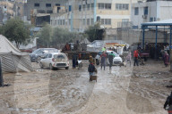 Gazans live in makeshift tents amidst building ruins