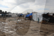 Gazans live in makeshift tents amidst building ruins