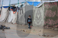 Gazans live in makeshift tents amidst building ruins