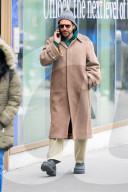 Bradley Cooper strolls in a cozy layered winter look in New York