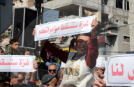 Palestinians including children, holding banners, gather in front of the Suheda Mosque to protest against U.S. President Donald Trump's
