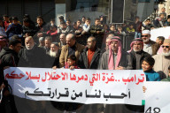 Palestinians including children, holding banners, gather in front of the Suheda Mosque to protest against U.S. President Donald Trump's
