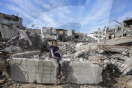 A view of the demolished residential area shows Palestinians continuing their daily lives under difficult conditions in the Bureij refugee camp, struggling to survive amid the rubble of buildings destroyed by Israeli attacks in the Gaza Strip