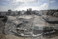 A view of the demolished residential area shows Palestinians continuing their daily lives under difficult conditions in the Bureij refugee camp, struggling to survive amid the rubble of buildings destroyed by Israeli attacks in the Gaza Strip