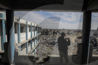 A view of the demolished residential area shows Palestinians continuing their daily lives under difficult conditions in the Bureij refugee camp, struggling to survive amid the rubble of buildings destroyed by Israeli attacks in the Gaza Strip