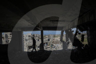 A view of the demolished residential area shows Palestinians continuing their daily lives under difficult conditions in the Bureij refugee camp, struggling to survive amid the rubble of buildings destroyed by Israeli attacks in the Gaza Strip