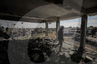 A view of the demolished residential area shows Palestinians continuing their daily lives under difficult conditions in the Bureij refugee camp, struggling to survive amid the rubble of buildings destroyed by Israeli attacks in the Gaza Strip