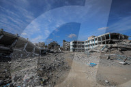 A view of the demolished residential area shows Palestinians continuing their daily lives under difficult conditions in the Bureij refugee camp, struggling to survive amid the rubble of buildings destroyed by Israeli attacks in the Gaza Strip