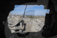 A view of the demolished residential area shows Palestinians continuing their daily lives under difficult conditions in the Bureij refugee camp, struggling to survive amid the rubble of buildings destroyed by Israeli attacks in the Gaza Strip
