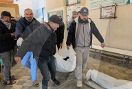 Palestinians mourn at a hospital after an Israeli strike killed three policemen, according to the Hamas-run interior ministry, in Khan Younis