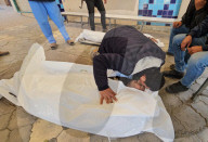 Palestinians mourn at a hospital after an Israeli strike killed three policemen, according to the Hamas-run interior ministry, in Khan Younis
