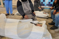 Palestinians mourn at a hospital after an Israeli strike killed three policemen, according to the Hamas-run interior ministry, in Khan Younis