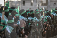 Hamas' Al-Qassam Brigades show of force during handover of hostage bodies