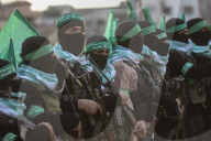 Hamas' Al-Qassam Brigades show of force during handover of hostage bodies