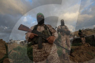 Hamas' Al-Qassam Brigades show of force during handover of hostage bodies