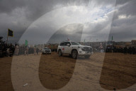 Hamas' Al-Qassam Brigades show of force during handover of hostage bodies