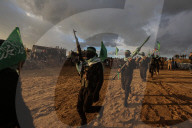 Hamas' Al-Qassam Brigades show of force during handover of hostage bodies