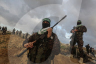 Hamas' Al-Qassam Brigades show of force during handover of hostage bodies