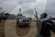 Hamas' Al-Qassam Brigades show of force during handover of hostage bodies