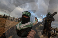 Hamas' Al-Qassam Brigades show of force during handover of hostage bodies