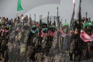 Hamas' Al-Qassam Brigades show of force during handover of hostage bodies