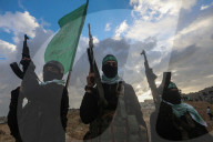 Hamas' Al-Qassam Brigades show of force during handover of hostage bodies