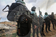 Hamas' Al-Qassam Brigades show of force during handover of hostage bodies