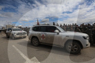 Heavily armed Hamas fighters attend handover of Israeli hostages