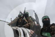 Heavily armed Hamas fighters attend handover of Israeli hostages