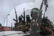 Heavily armed Hamas fighters attend handover of Israeli hostages