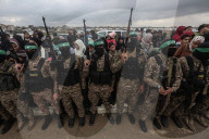 Heavily armed Hamas fighters attend handover of Israeli hostages