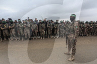 Heavily armed Hamas fighters attend handover of Israeli hostages