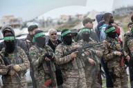Heavily armed Hamas fighters attend handover of Israeli hostages