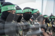 Heavily armed Hamas fighters attend handover of Israeli hostages