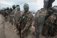 Heavily armed Hamas fighters attend handover of Israeli hostages