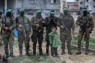 Heavily armed Hamas fighters attend handover of Israeli hostages