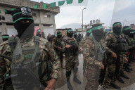 Heavily armed Hamas fighters attend handover of Israeli hostages