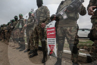 Heavily armed Hamas fighters attend handover of Israeli hostages