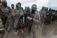 Heavily armed Hamas fighters attend handover of Israeli hostages